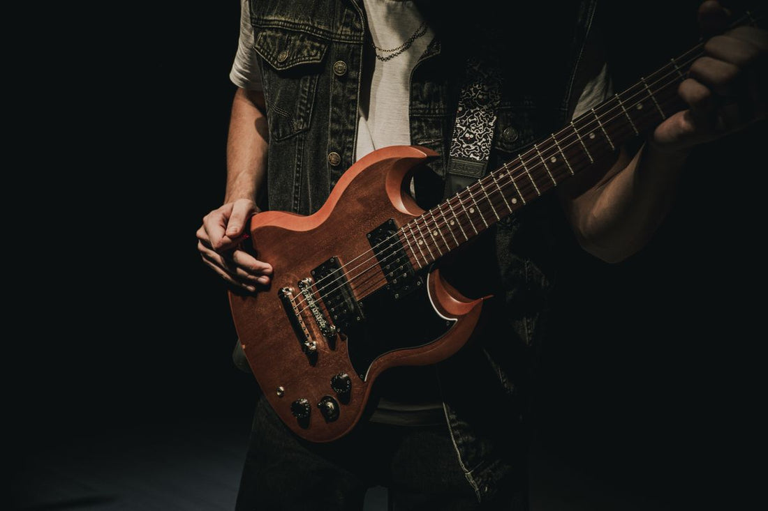 Electric guitarist shredding under dramatic lighting, capturing the energy of high-gain guitar tone