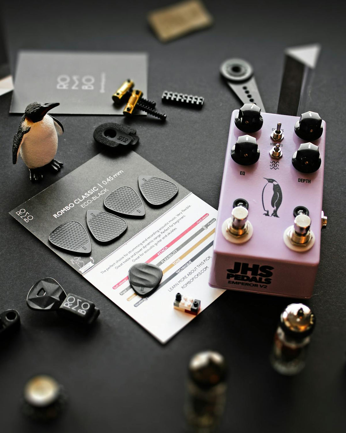 Guitar pedalboard with effects pedals and cables in a studio setup