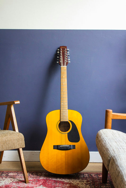 Guitar recording studio setup with microphone positioned near amplifier for tracking electric guitar tones
