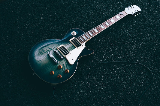 Electric guitar player performing live on stage with dramatic lighting