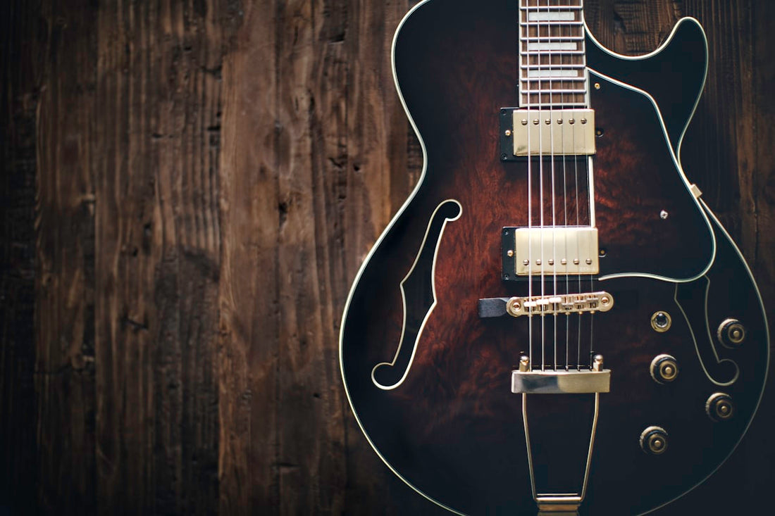 Close-up of electric guitar pickups and strings showing humbucker and single coil detail