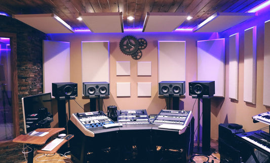 Close-up of a guitar amplifier control knobs and input jack in a home studio setting