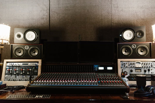 Professional recording studio mixing console with monitors, representing mix-ready guitar tone