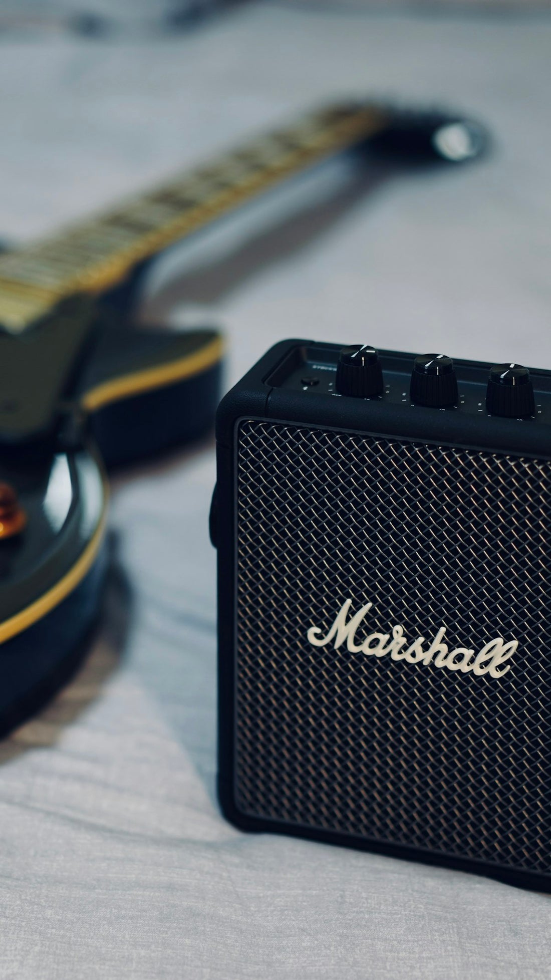 Close up of a Marshall guitar amplifier speaker cabinet in black and gray